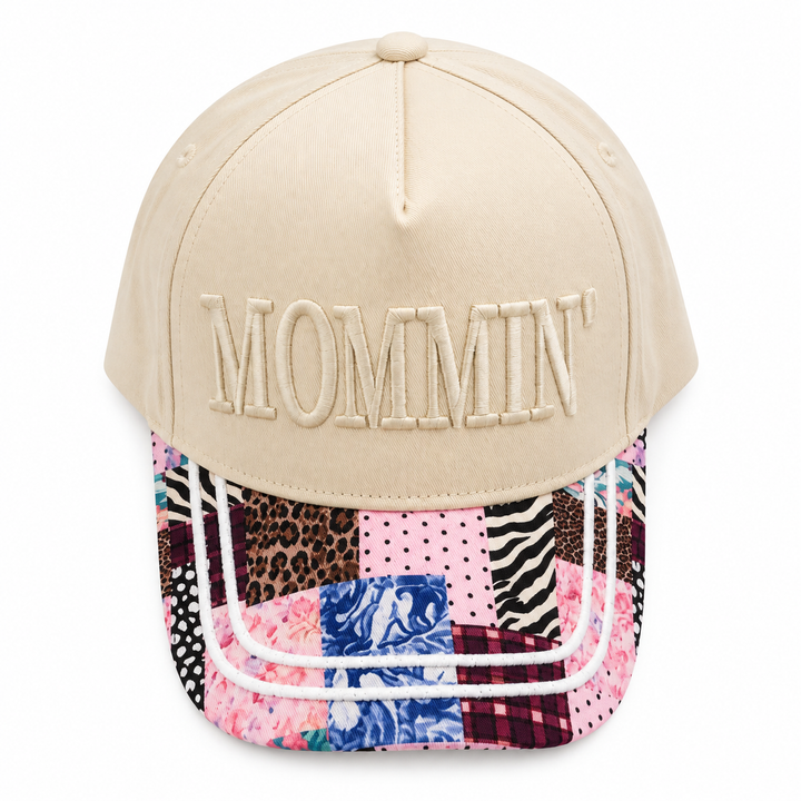 Mommin embroidered faux patchwork trucker hat on a clean white background