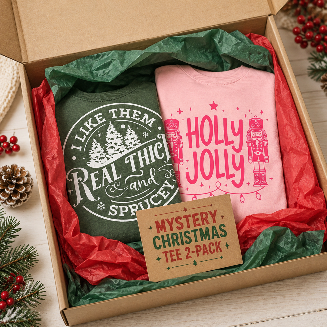 Mystery Comfort Colors Christmas tee two-pack gift box with two example holiday graphic shirts; designs vary