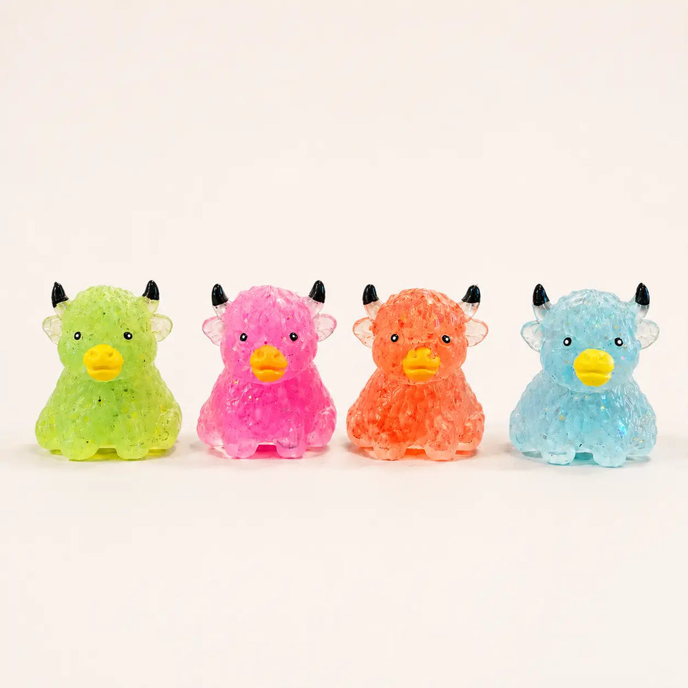 Four colorful Highland cow sugar texture squishy toys in green, pink, orange, and blue, product view