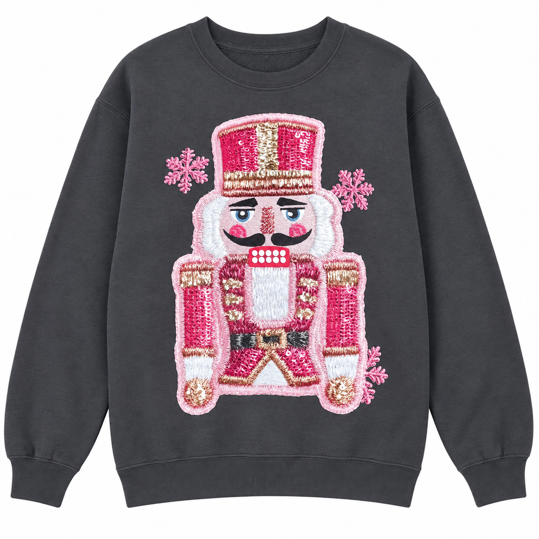 Charcoal pink faux-stitched nutcracker Christmas crewneck laid flat on pure white