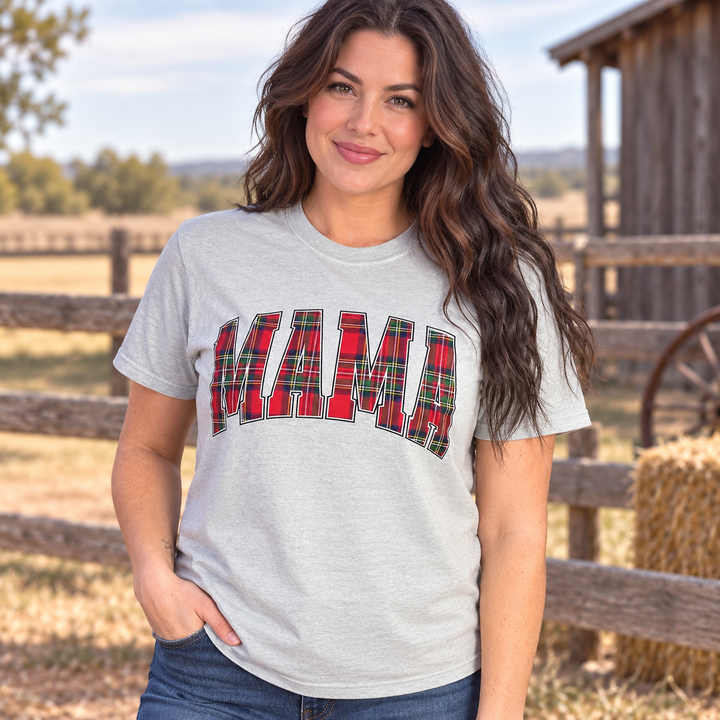 Brunette woman wearing the Plaid Mama sage buffalo check graphic tee in a close Western portrait