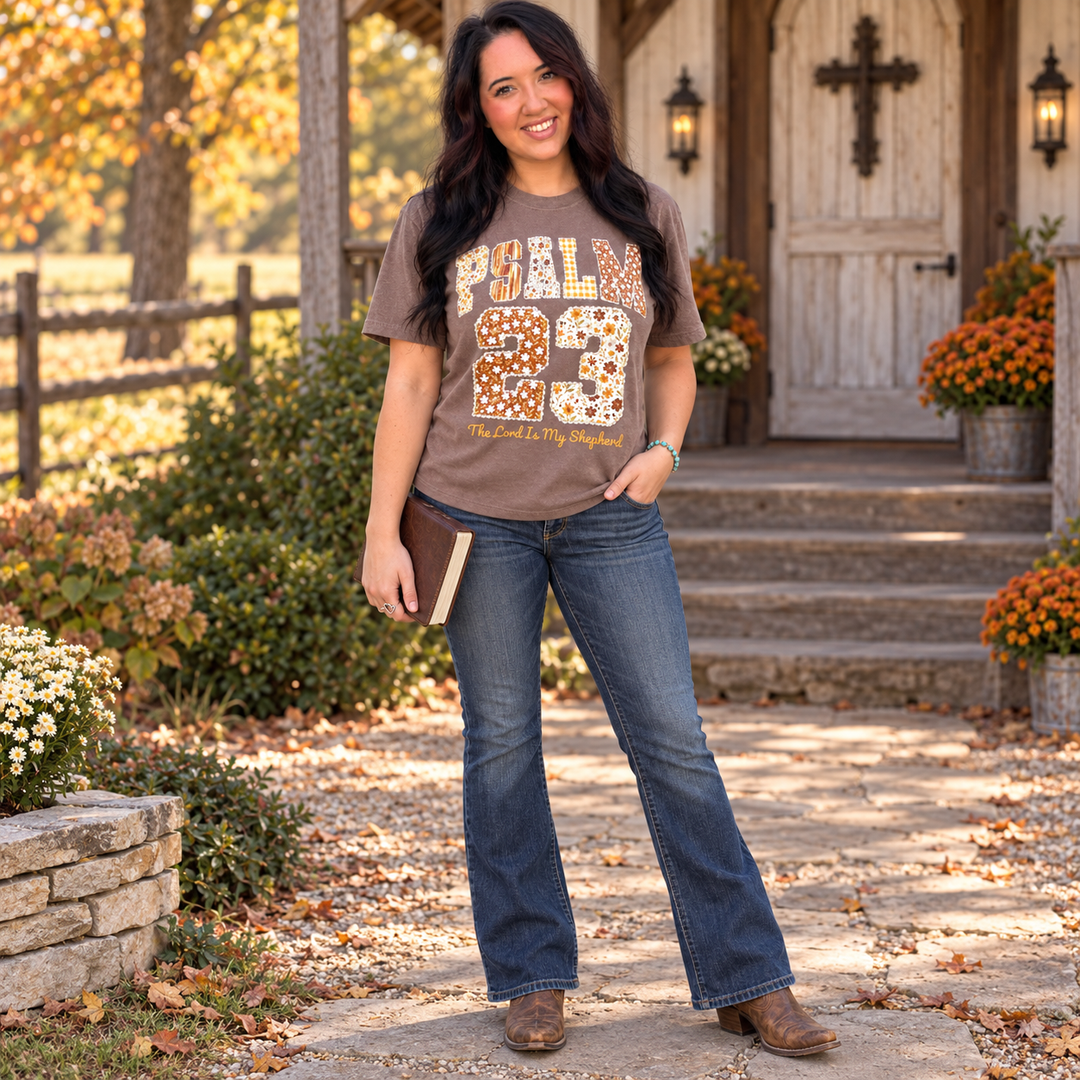 Woman wearing Psalm 23 espresso faith graphic tee at a country chapel