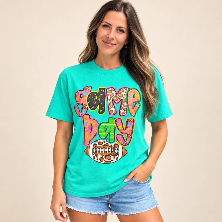 Retro colorful Game Day turquoise graphic tee on model, front view