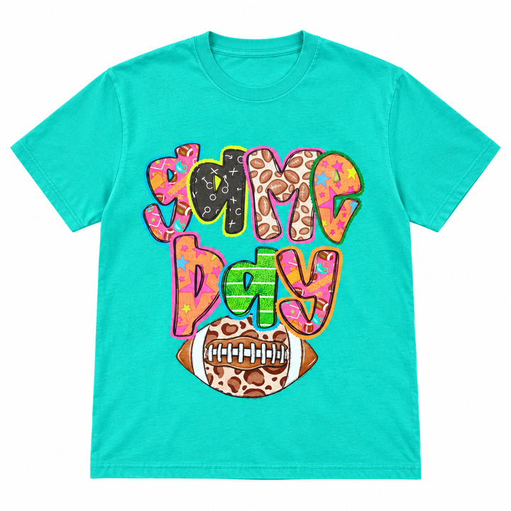 Retro colorful Game Day turquoise graphic tee, white background flat lay