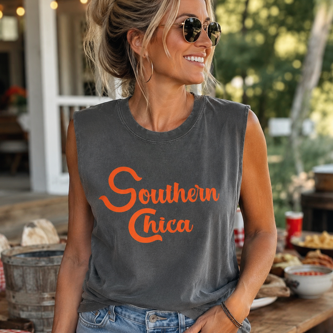 Woman wearing a faded black Southern Chica orange-script muscle tank