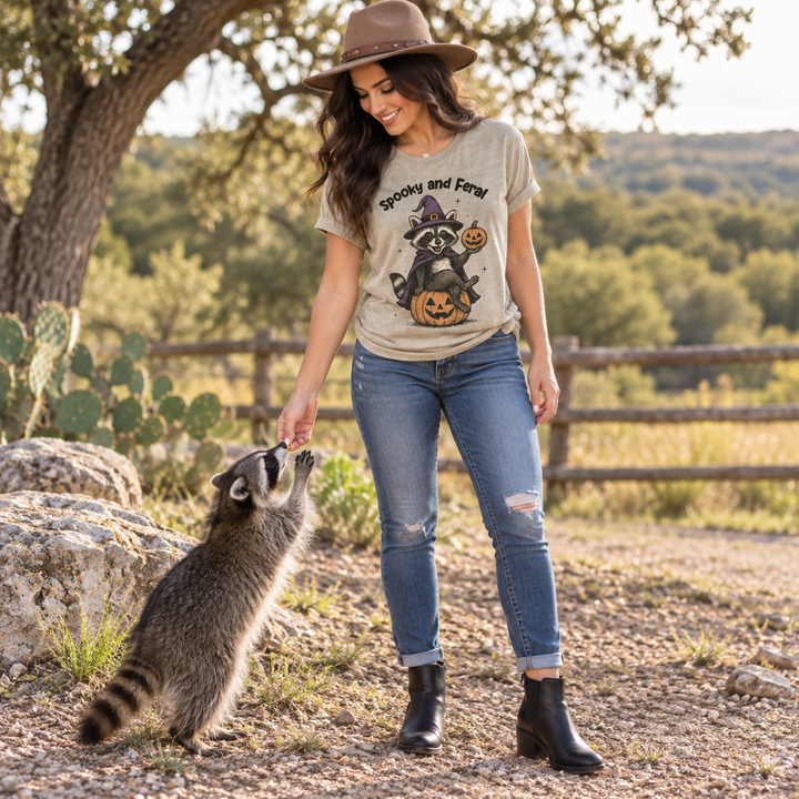 Woman wearing Spooky and Feral raccoon tee in a Texas ranch setting