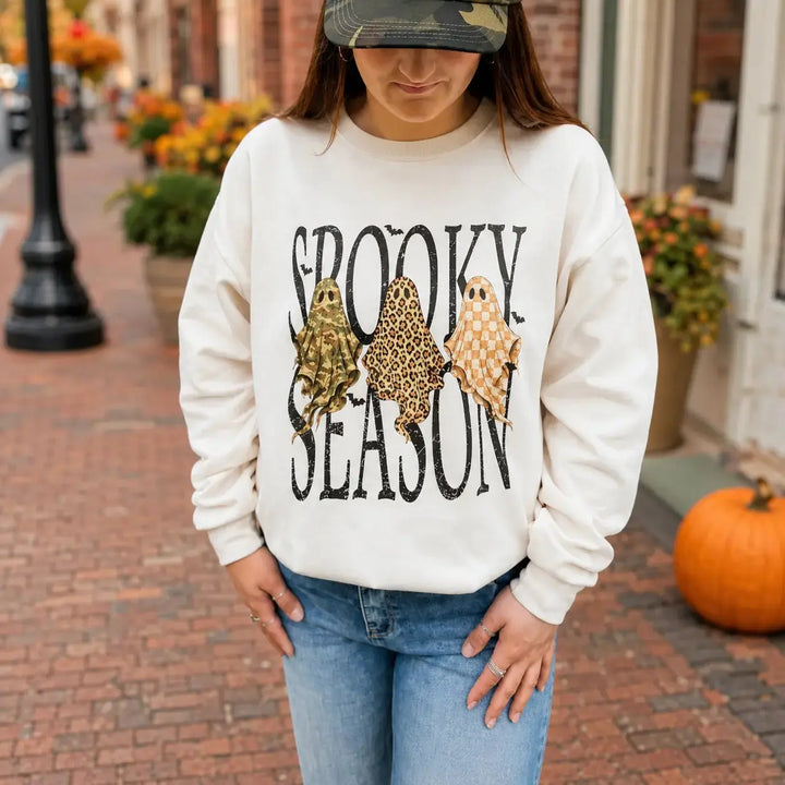 Woman wearing the Spooky Season trio ghost Off White crewneck on an autumn street