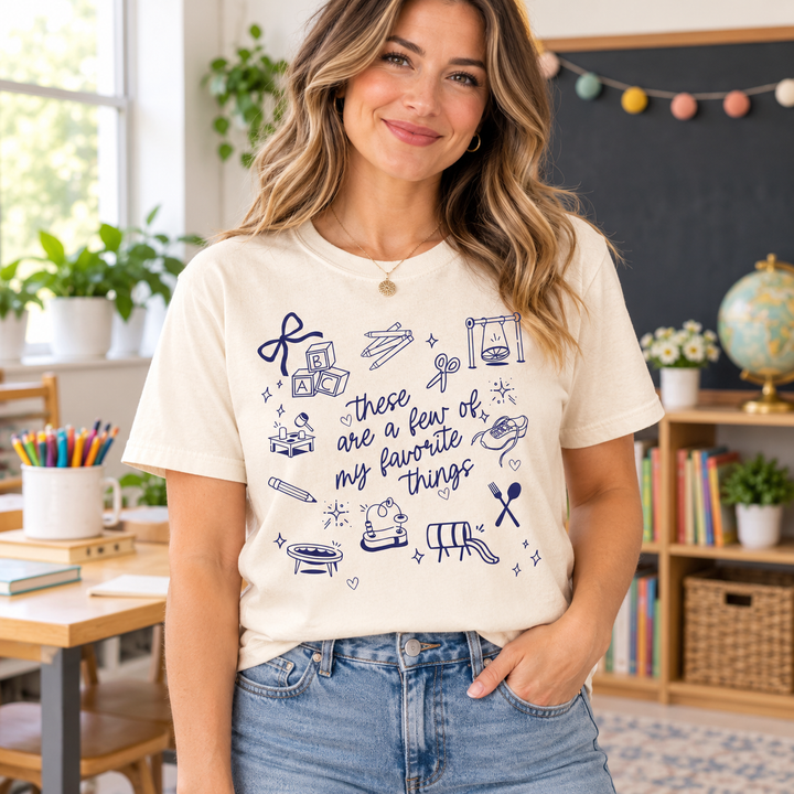 Woman teacher wearing Teacher Favorite Things Ivory graphic T-shirt