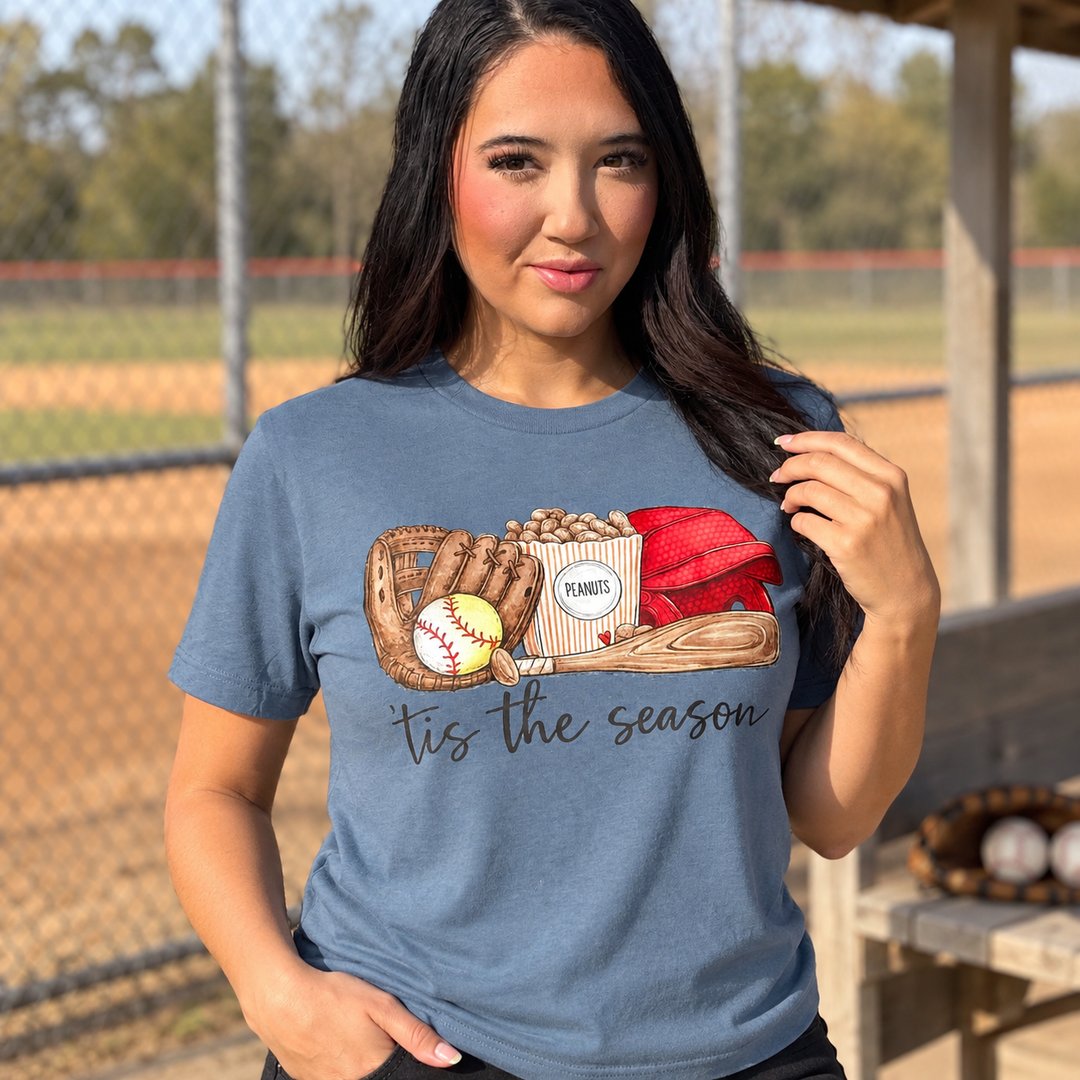 Tis the Season dusty blue baseball graphic tee close model view at a small-town ballfield
