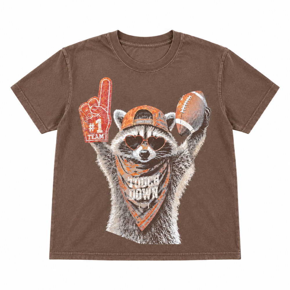 Touchdown Raccoon espresso football graphic tee single-garment lay-flat on pure white