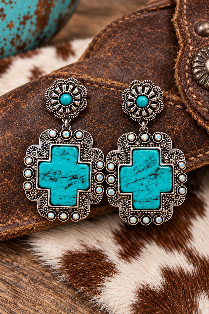 Turquoise Cross Statement Earrings styled on Western leather and cowhide