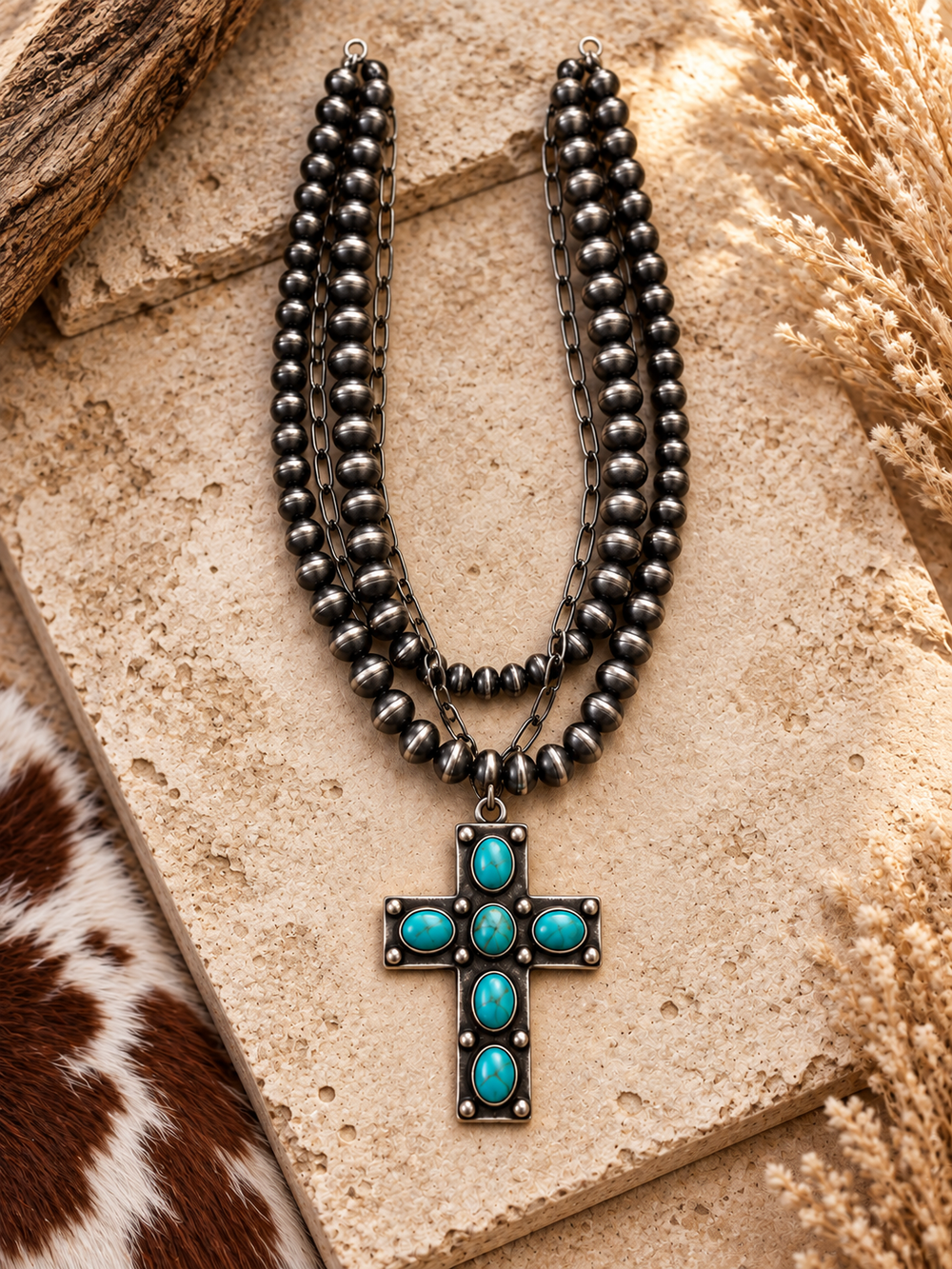 Close styled view of Turquoise Faith Cross Necklace with layered silver-tone beads and turquoise cross pendant