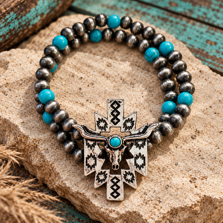 Close styled view of Turquoise Longhorn Aztec Bracelet with silver-tone and turquoise beads and longhorn skull charm