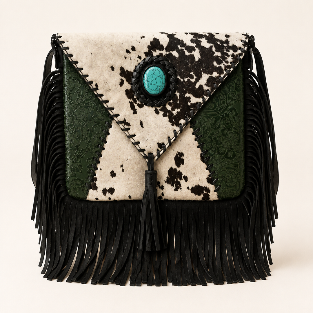 Turquoise Trail spotted cowhide bag with green tooled leather, turquoise concho and black fringe, front product view