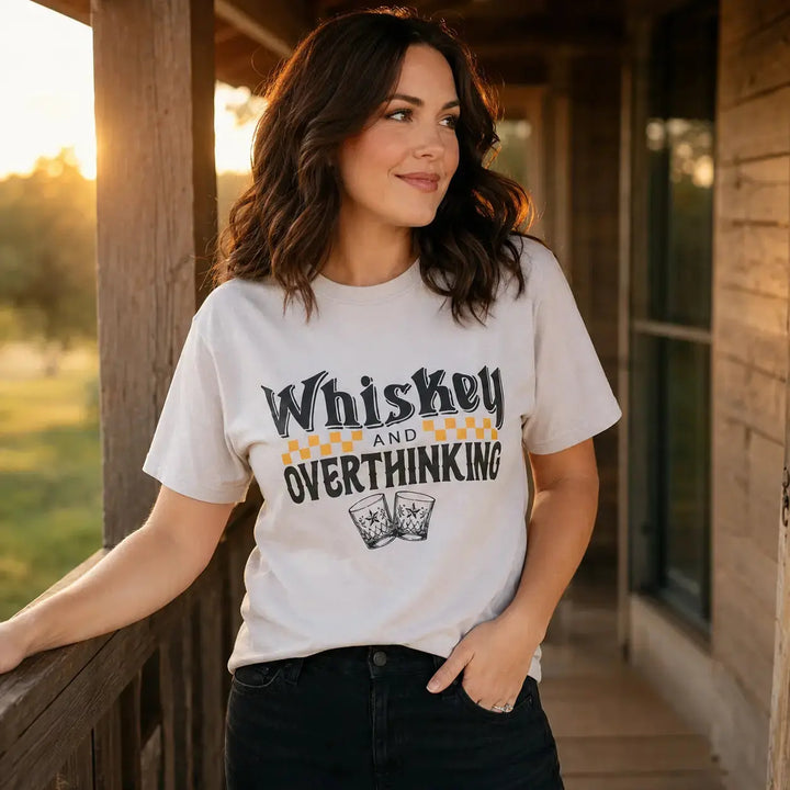 Woman wearing the Whiskey and Overthinking graphic tee on a rustic porch