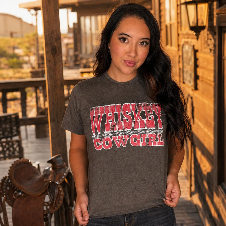 Whiskey Cowgirl graphic T-shirt in a Western ranch lifestyle setting