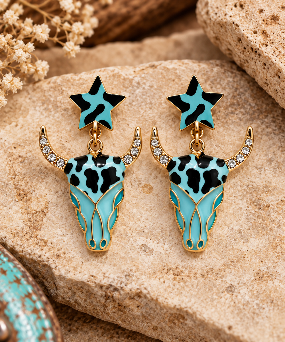 Close styled view of Wild Turquoise Longhorn Earrings with star tops, turquoise-and-black pattern, and rhinestone horns