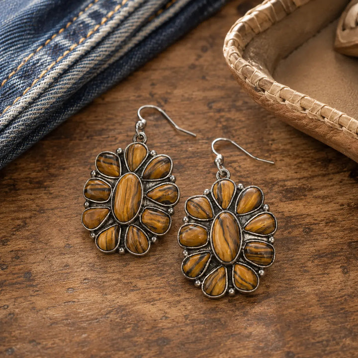Woodgrain concho dangle earrings styled with denim on a rustic wooden vanity